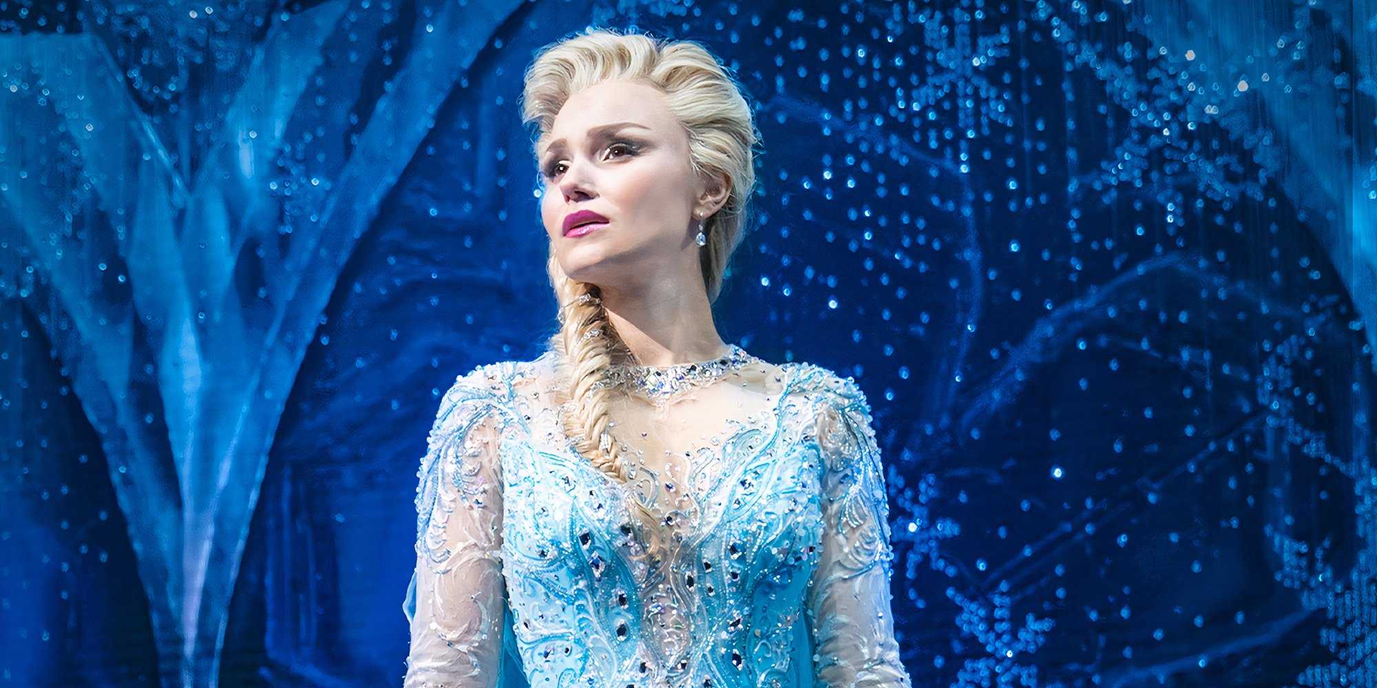 Elsa dramatically looks off to the side in the Frozen Musical