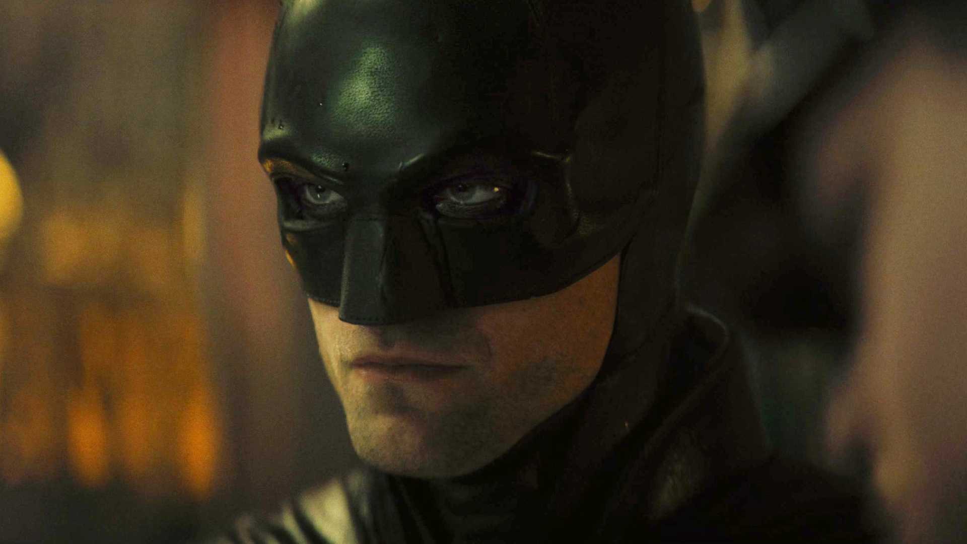 Robert Pattinson's Batman paying attention to something in The Batman