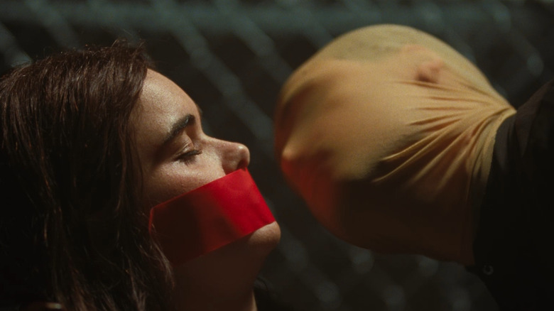 Faces of Death: Horror digital supera o choque A captive Margot is menaced by a masked Arthur in Faces of Death